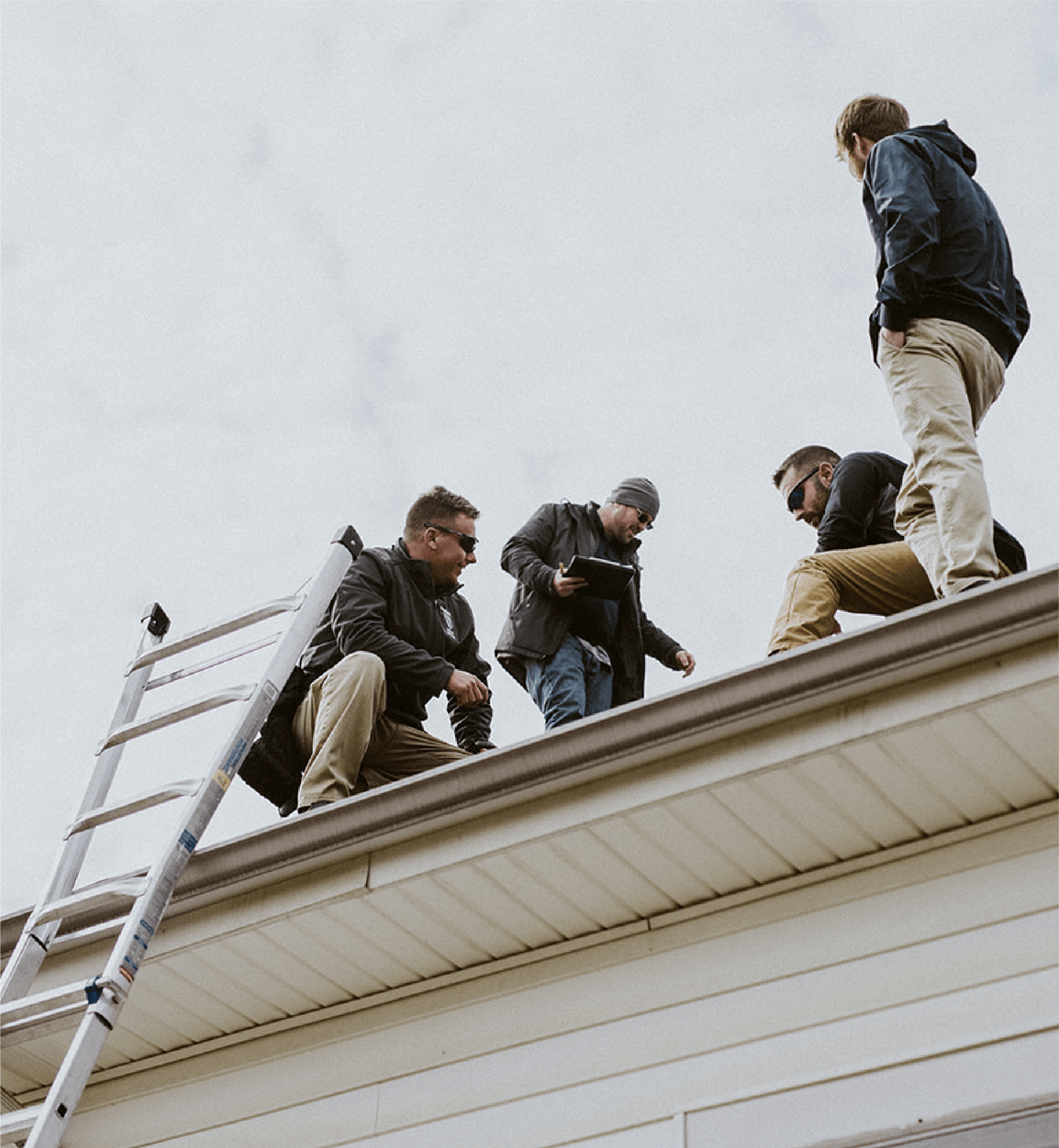 men working on a roof with a ladder