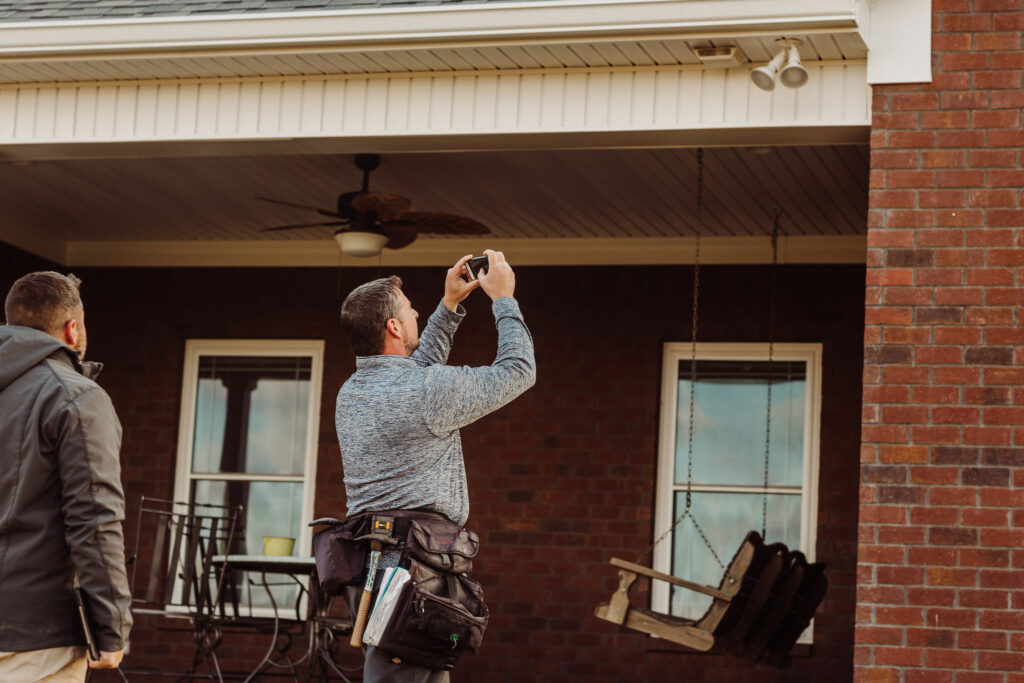 Two Knight's Solutions technicians taking photographs of a property for an inspection. 