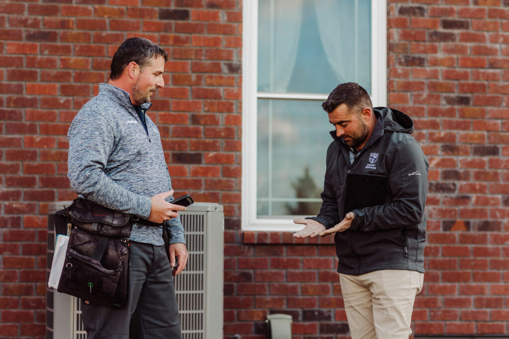 Two Knight's Solutions technicians talk on an inspection site.