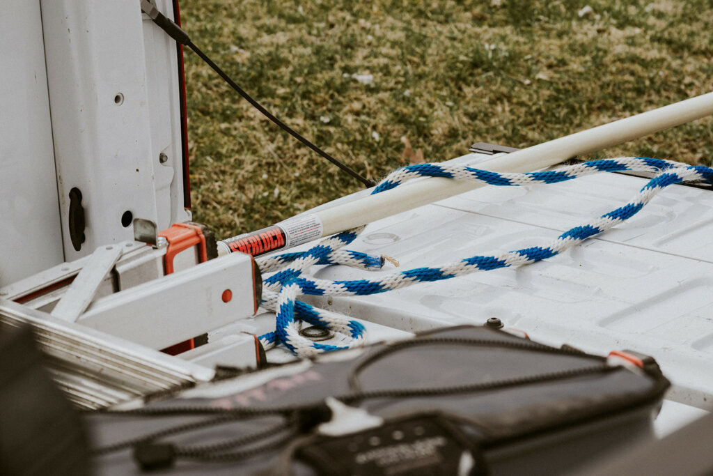 A rope and harness and other roof inspection equipment on a roof top.