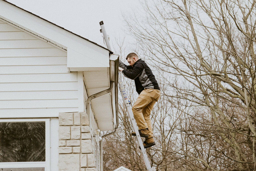 A Knight's Solutions Technician climbing down a ladder.